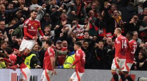 Manchester United’s English defender #05 Harry Maguire (2L) and teammates celebrate with their fans after Maguire scores their fifth goal during the UEFA Europa league quarter-final final, second leg football match between Manchester United and Lyon at Old Trafford stadium in Manchester, north west England, on April 17, 2025. (Photo by Oli SCARFF / AFP)