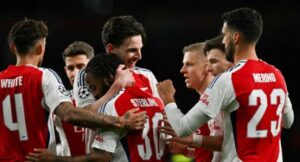 Arsenal’s English midfielder #41 Declan Rice (C) celebrates with teammates after scoring his team second goal during the last 16 second leg UEFA Champions League football match between Arsenal and PSV Eindhoven at the Emirates Stadium in north London on March 12, 2025. (Photo by Glyn KIRK / AFP)