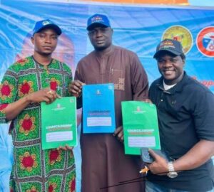 Mr Amodu Shehu, Lagos Mainland Local Government Chairmanship aspirant (middle) with two other councillorship aspirants displaying their nomination forms.