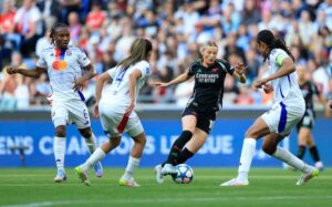 Arsenal’s Chloe Kelly dribbles past Olympique Lyonnais’ Melchie Dumornay, Selma Bacha and Wendie Renard during the Women’s Champions League semifinal second leg at the Groupama Stadium, Lyon, France(PhotoCredit:Reuters)