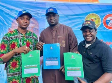 Mr Amodu Shehu, Lagos Mainland Local Government Chairmanship aspirant (middle) with two other councillorship aspirants displaying their nomination forms.