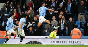 Manchester City’s Portuguese midfielder #27 Matheus Nunes (R) celebrates after scoring his team second goal during the English Premier League football match between Manchester City and Aston Villa at the Etihad Stadium in Manchester, north west England, on April 22, 2025. (Photo by Oli SCARFF / AFP)