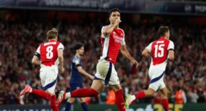 Arsenal’s Spanish midfielder #23 Mikel Merino (C) celebrates after scoring a goal that will be disallowed due to an offside position during the UEFA Champions League Semi-final First Leg football match between Arsenal and Paris Saint-Germain (PSG) at the Emirates Stadium in north London, on April 29, 2025. (Photo by Adrian Dennis / AFP)