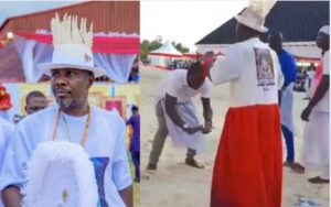 Tompolo, dressed in white and red attire, is seen dancing while a man repeatedly throws ₦1,000 notes into the air — a practice outlawed by the Central Bank of Nigeria (CBN).