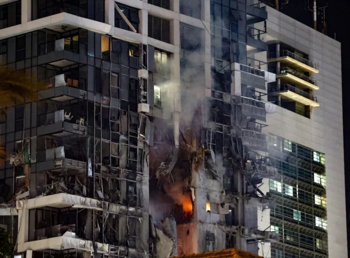 Fire and smoke rise from a building, reportedly hit by a missile fired from Iran, in central Tel Aviv Credit: JACK GUEZ/AFP