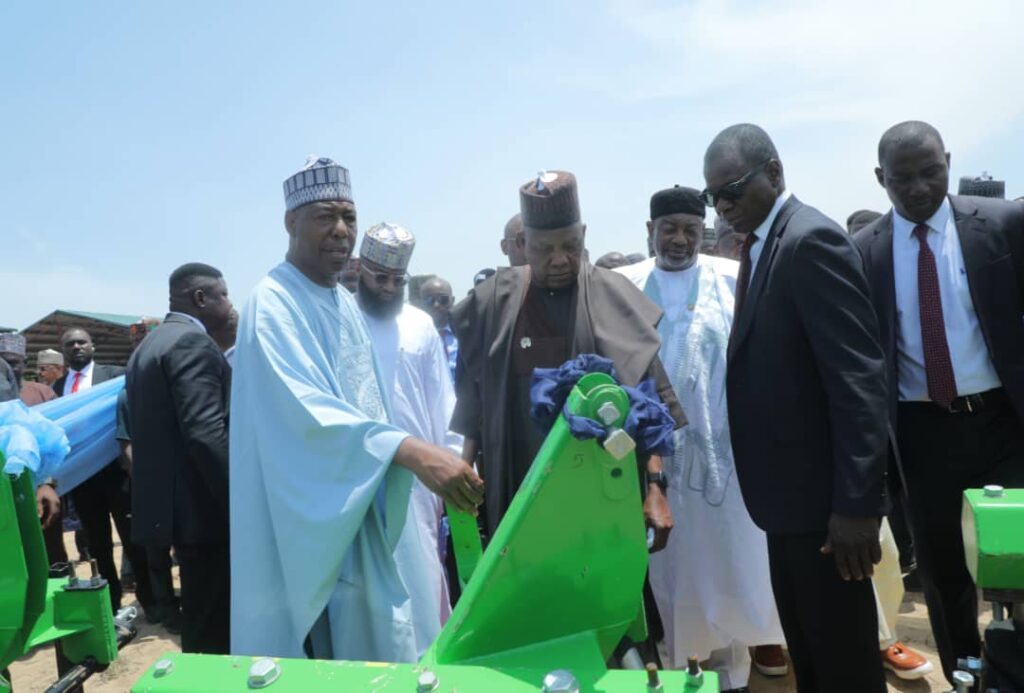 Vice President Kashim Shettima (2nd right) flanked by Governor Babagana Zulum (right) during the commissioning of 375 refurbished tractors by the Borno State Government in Maiduguri."