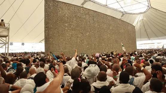 Muslims pilgrims performing the ritual of stoning the Jamarat