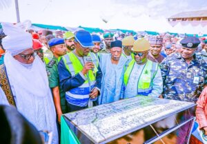 Governor Sule, supported by Senator Abdullahi Adamu and Emir of Keffi, performing the ground breaking flagg of the construction of Keffi fly over.