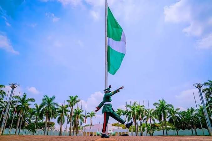 A soldier parading before the Nigeria National flag