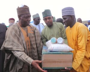 Borno State Governor Babagana Zulum, distributing bag of fertilizer to one of the beneficiaries