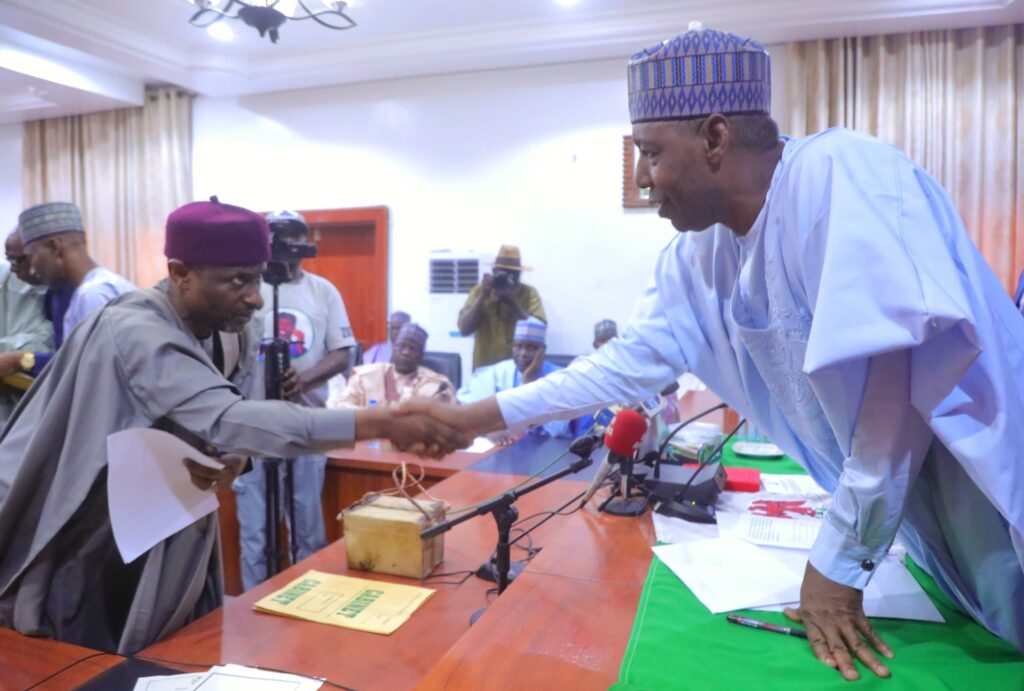 Borno State Governor Babagana Zulum exchanging pleasantry with one of the newly inaugurated commissioners