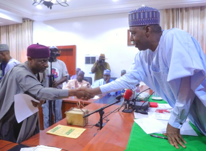 Borno State Governor Babagana Zulum exchanging pleasantry with one of the newly inaugurated commissioners