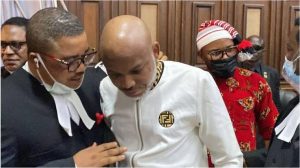 Embattled IPOB leader, Nnamdi Kanu listening to an explanation by one of his lawyers