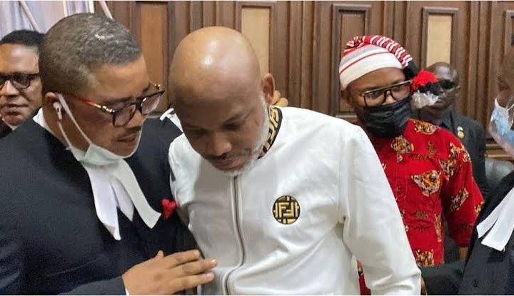 Embattled IPOB leader, Nnamdi Kanu listening to an explanation by one of his lawyers