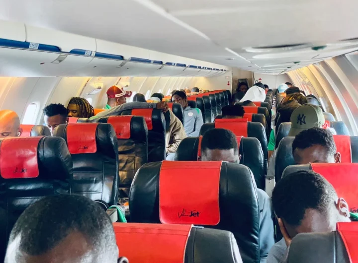 Super Eagles players and team officials inside an aircraft