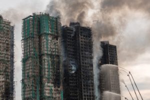 Smoke rises from apartments after a major fire swept through several blocks at the Wang Fuk Court residential estate in Hong Kong’s Tai Po district on November 27, 2025. DALE DE LA REY / AFP