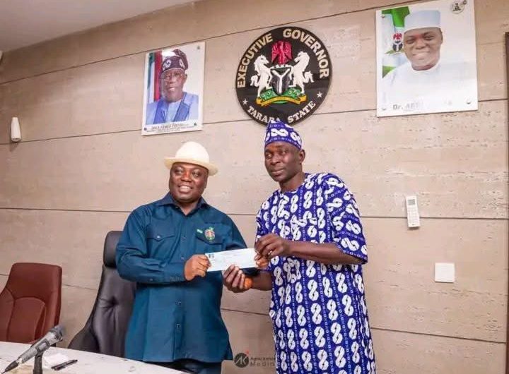 Taraba State Governor, Agbu Kefas displaying his APC membership card at the Government House, Jalingo