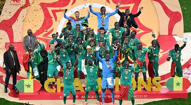 Senegal players celebrate with the trophy after winning the Africa Cup of Nations (CAN) final football match against Morocco at the Prince Moulay Abdellah Stadium in Rabat on January 18, 2026. (Photo by Paul ELLIS / AFP)
