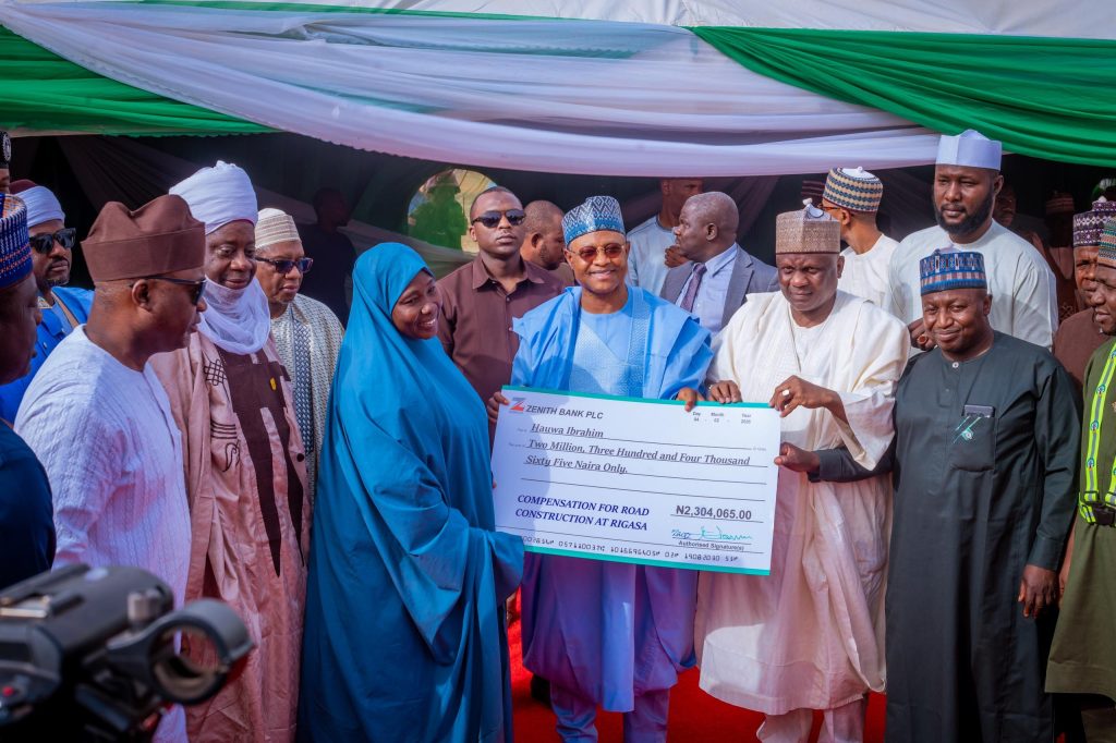 Kaduna State Governor, Uba Sani presenting cheque (compensation) to one of the households affected by the ongoing Rigasa township road projects