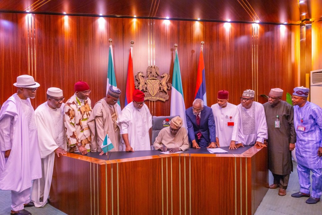 President Bola Tinubu (seated) signing the Electoral Act 2026 Into Signs Electoral Act 2026 Into Law