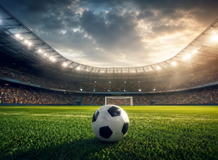 Football stadium with ball under dramatic evening lights