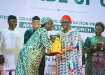 One of the beneficiaries receiving a gas cylinder from Ekaette Unoma Akpabio, wife of Senate President in the presence of Governor Umo Eno and Ekperikpe Ekpo, minister of Petroleum Resources (Gas) in Uyo, Akwa Ibom State